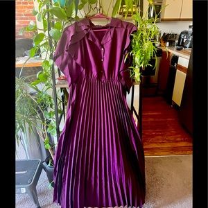 Purple floor length satin pleated dress.